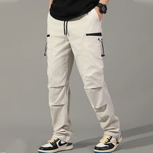 Cargar imagen en el visor de la galería, Pantalones: Estilo cargo. Moda coreana. Con múltiples bolsillos. Sueltos, rectos y con cordón ajustable. Varios colores sólidos.

